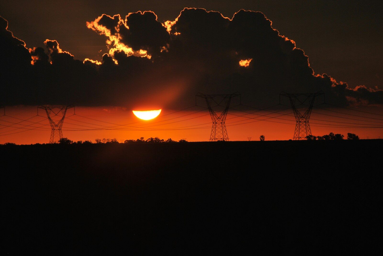 silhouette of wire towers at sunset